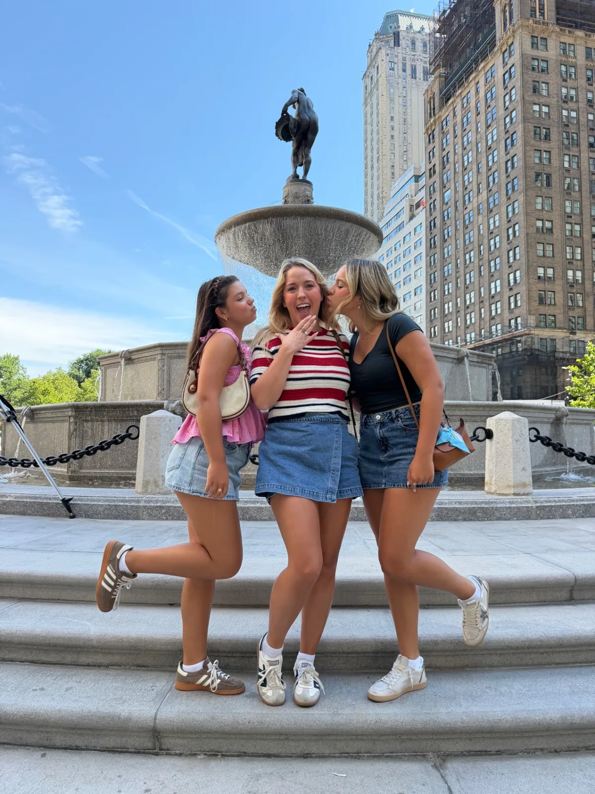 Three Gossip Girl Tours guests recreating a playful Serena and Blair photo at Pulitzer Fountain