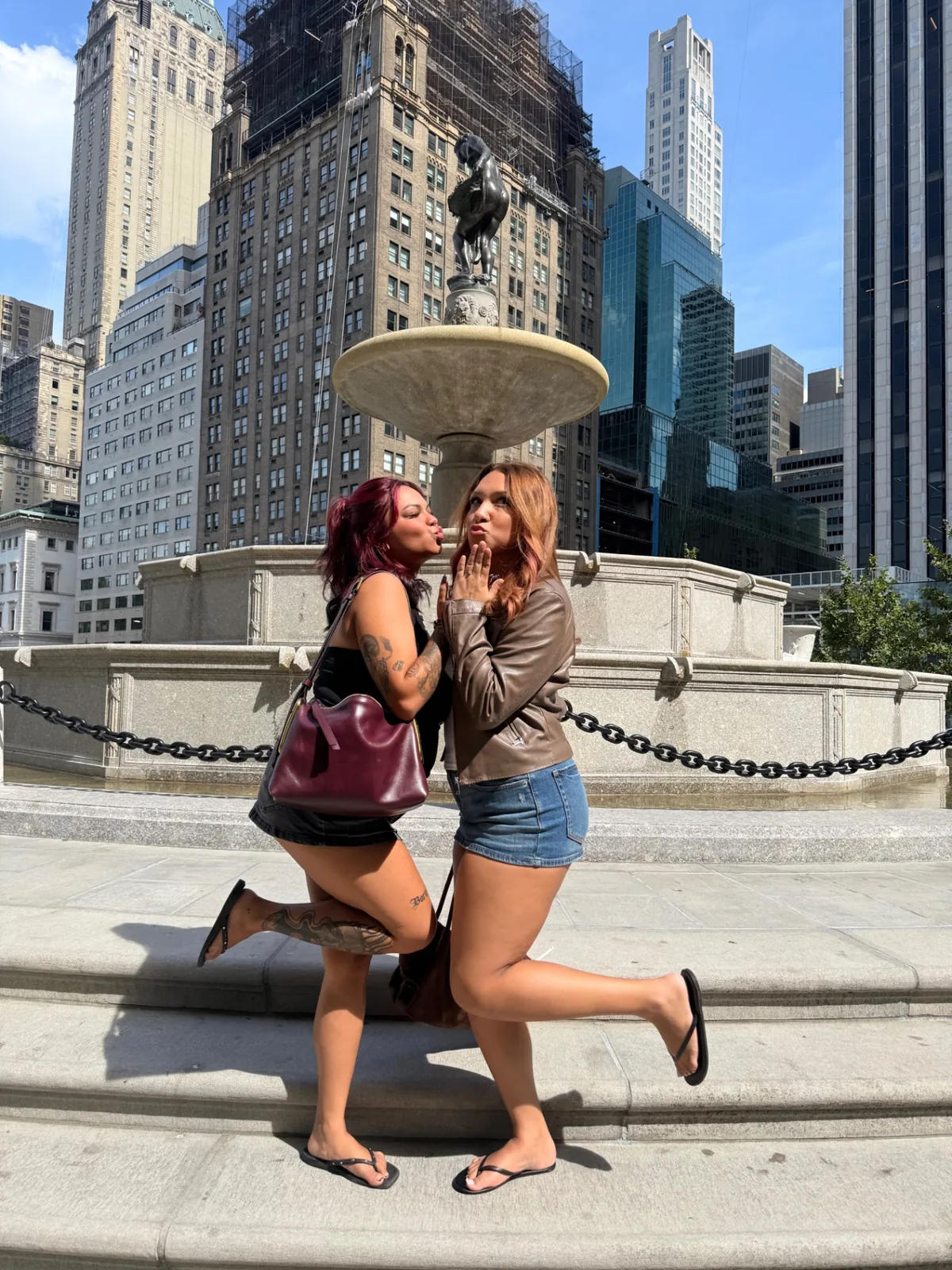 Gossip Girl Tours guests recreating the Serena and Blair photo shoot pose at Pulitzer Fountain in NYC