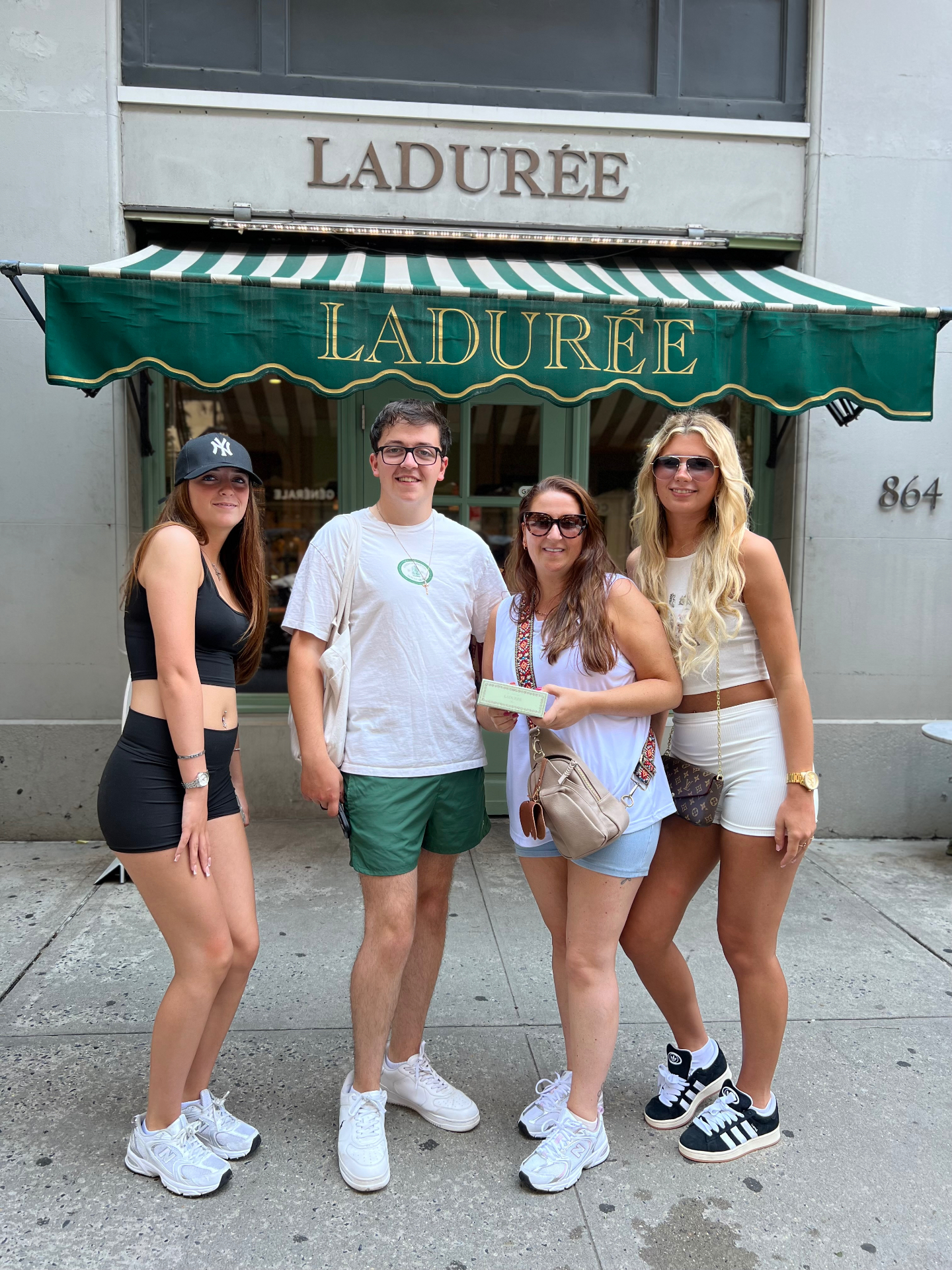 Four guests outside Ladurée on a Friendly Gossip Girl Tour in New York City