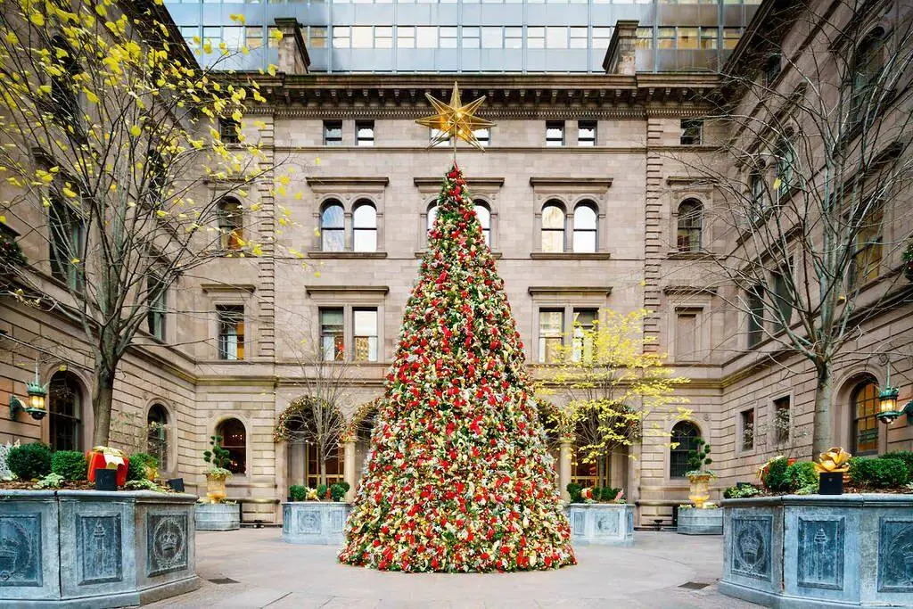 Decorated holiday tree in the Lotte New York Palace courtyard in December — Gossip Girl Tours winter photo stop in New York